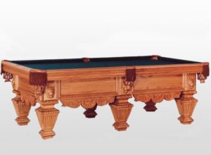 Ornate wooden billiard table with green felt.