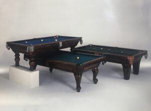 Three stacked billiards tables with balls.